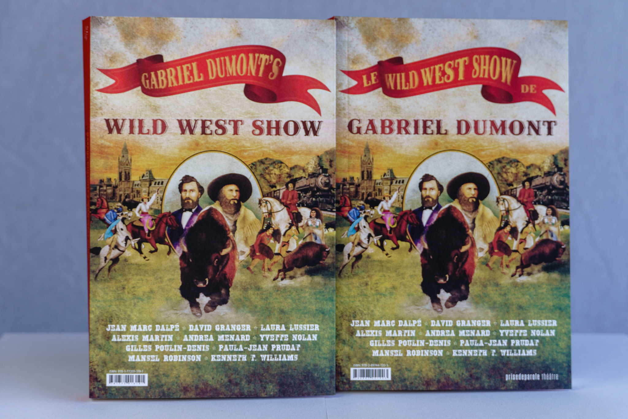 Image shows the cover of the book, Gabriel Dumont's Wild West Show/Le Wild West Show de Gabriel Dumont, newly released by Talonbooks. The cover features pictures of Louis Riel, a bison charging, and Gabriel Dumont in the foreground, and Métis warriors and colonial officers in front of a legislature and an advancing train in the background.