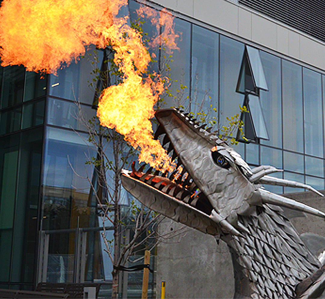 metal statue of a dragon with fire
